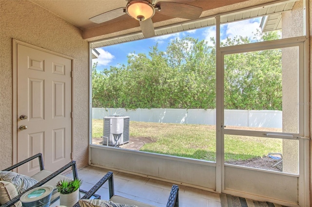 sunroom featuring ceiling fan and plenty of natural light