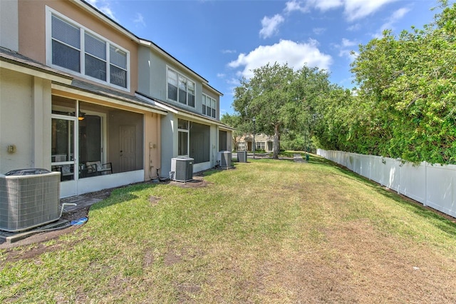 view of yard with fence and cooling unit