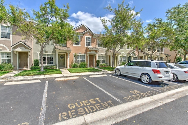 uncovered parking lot featuring a residential view