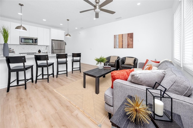 3402 E 28th Ave Unit 6, Tampa, FL 33605 - living room with light wood-style flooring, a ceiling fan, and recessed lighting