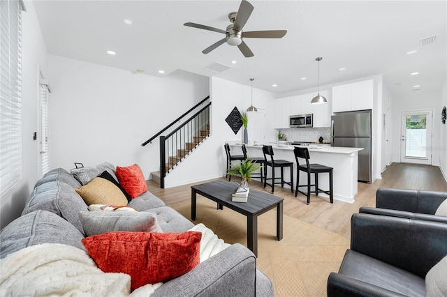 3402 E 28th Ave Unit 6, Tampa, FL 33605 - living area featuring stairs, light wood finished floors, a ceiling fan, and recessed lighting