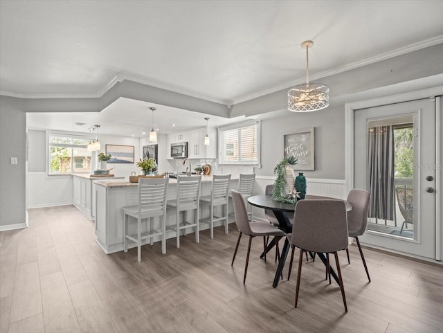 619 2nd St Unit 3, Indian Rocks Beach, FL 33785 - dining space featuring ornamental molding and light wood finished floors