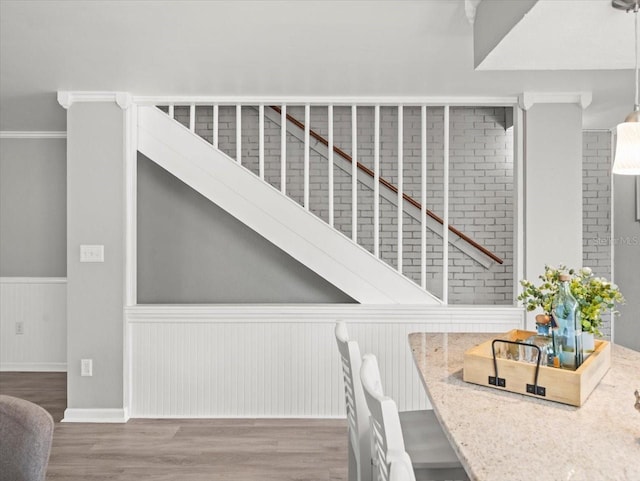 619 2nd St Unit 3, Indian Rocks Beach, FL 33785 - stairs featuring wainscoting and wood finished floors
