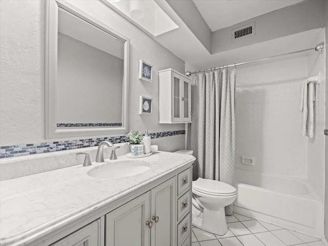 619 2nd St Unit 3, Indian Rocks Beach, FL 33785 - bathroom featuring tile patterned floors, a textured wall, toilet, vanity, and shower / bath combo with shower curtain