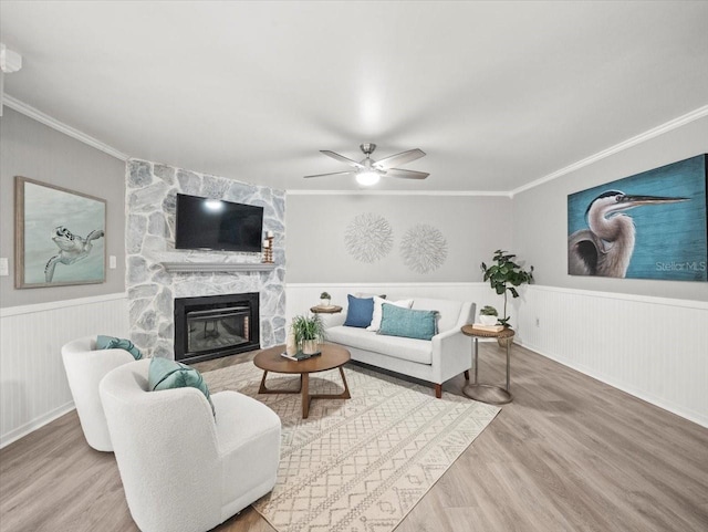 619 2nd St Unit 3, Indian Rocks Beach, FL 33785 - living area with wood finished floors, crown molding, ceiling fan, a fireplace, and wainscoting