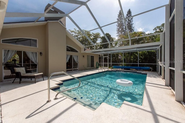 view of pool with a covered pool, a patio area, and glass enclosure