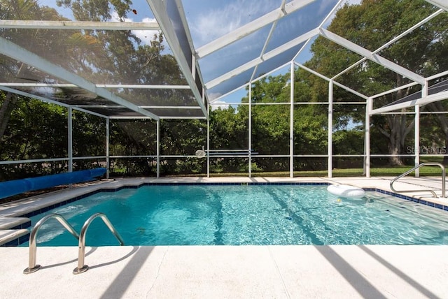 outdoor pool featuring a lanai and a patio