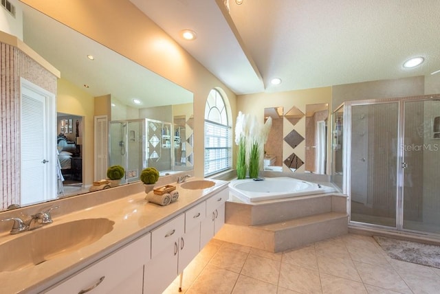 bathroom featuring a shower stall, a bath, a sink, and visible vents