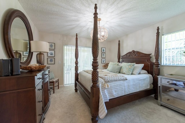bedroom featuring light carpet, a textured ceiling, and access to exterior