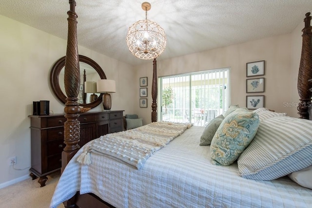 carpeted bedroom with baseboards, access to outside, a chandelier, and a textured ceiling