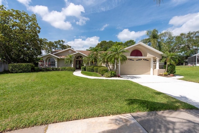 view of front of home featuring an attached garage, driveway, a front yard, and stucco siding