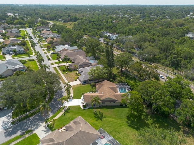 birds eye view of property with a residential view and a view of trees