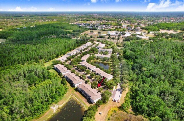 aerial view with a forest view and a water view