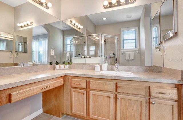 full bathroom with a shower stall and vanity