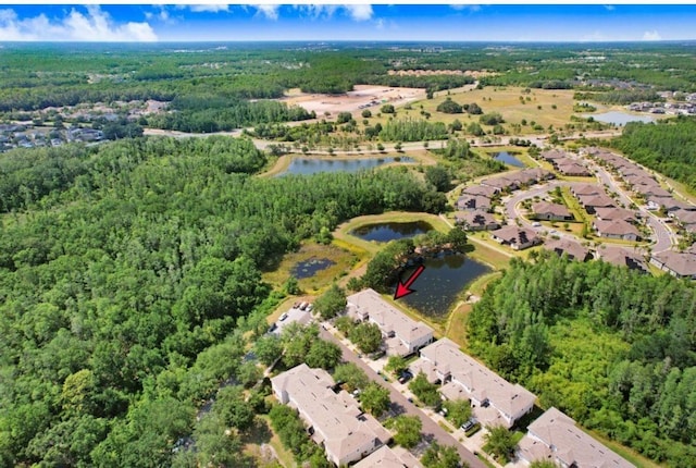 bird's eye view with a residential view, a wooded view, and a water view