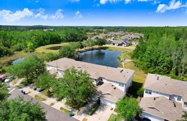 aerial view with a residential view, a wooded view, and a water view
