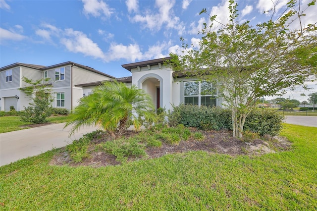 36959 Highland Meadows Ct, Zephyrhills, FL 33542 - view of front facade featuring driveway, stucco siding, a front lawn, and a garage