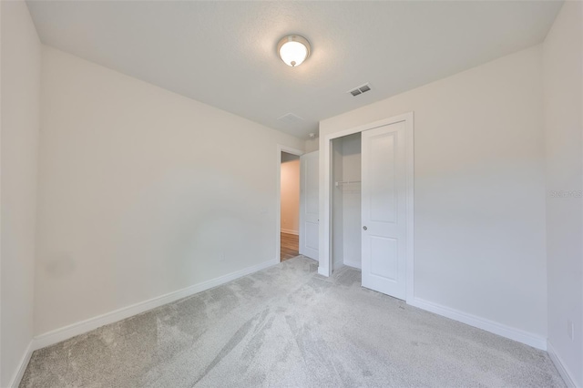 36959 Highland Meadows Ct, Zephyrhills, FL 33542 - unfurnished bedroom with light carpet, baseboards, and a closet