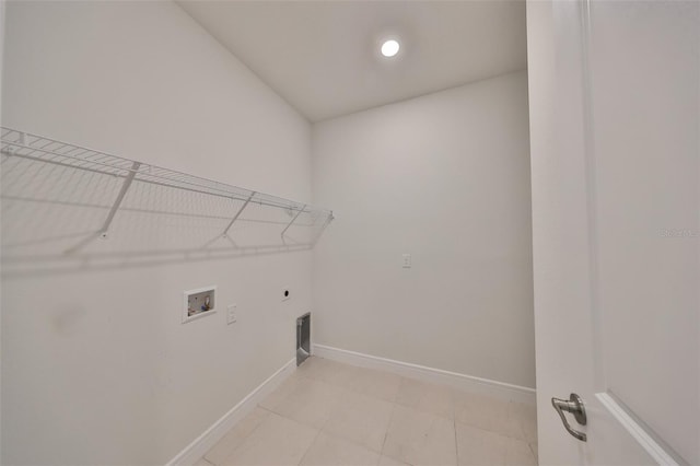 36959 Highland Meadows Ct, Zephyrhills, FL 33542 - laundry area with washer hookup, hookup for an electric dryer, baseboards, and light tile patterned flooring