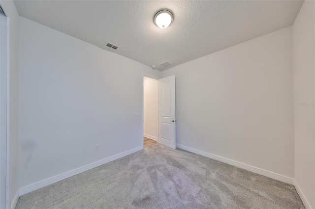 36959 Highland Meadows Ct, Zephyrhills, FL 33542 - carpeted empty room featuring baseboards and a textured ceiling