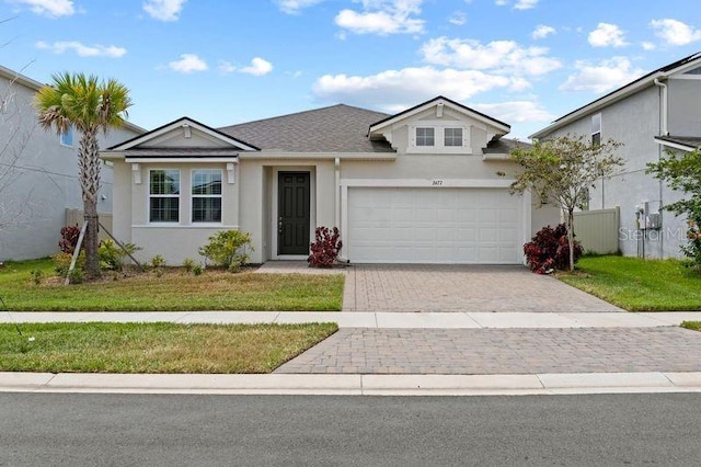 2477 Water Willow Dr, Lutz, FL 33558 - view of front of property featuring a garage, driveway, a front lawn, and stucco siding