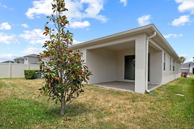 2477 Water Willow Dr, Lutz, FL 33558 - rear view of house with a lawn, a patio, stucco siding, and fence
