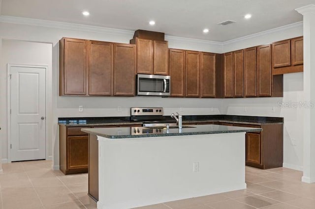2477 Water Willow Dr, Lutz, FL 33558 - kitchen with appliances with stainless steel finishes, a center island with sink, light tile patterned flooring, and visible vents