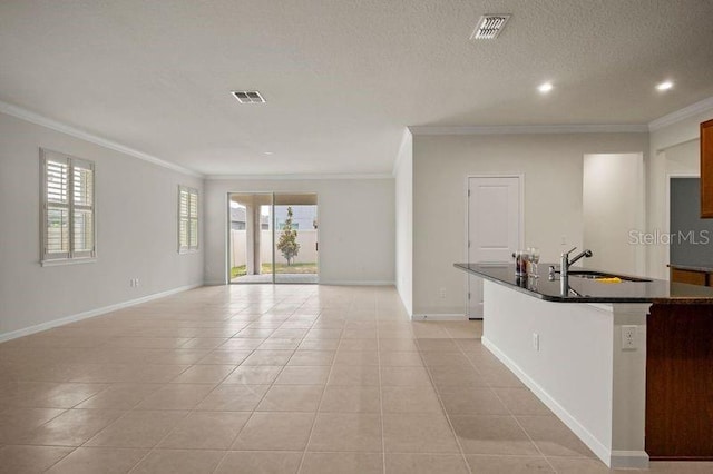 2477 Water Willow Dr, Lutz, FL 33558 - kitchen with dark countertops, visible vents, ornamental molding, and light tile patterned floors