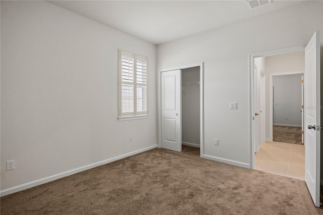 2477 Water Willow Dr, Lutz, FL 33558 - unfurnished bedroom featuring tile patterned floors, a closet, carpet, baseboards, and visible vents