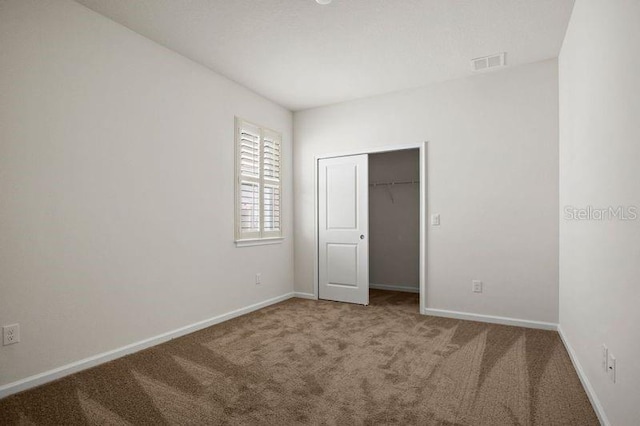 2477 Water Willow Dr, Lutz, FL 33558 - unfurnished bedroom with baseboards, carpet flooring, visible vents, and a closet
