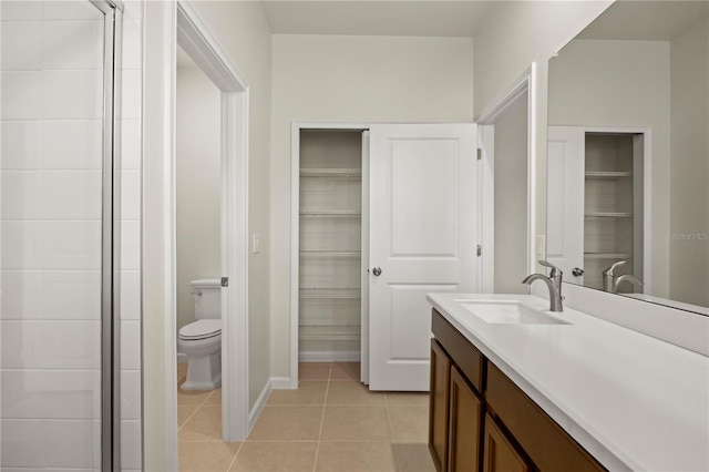 2477 Water Willow Dr, Lutz, FL 33558 - full bathroom with vanity, toilet, tile patterned flooring, and a spacious closet
