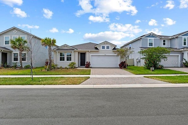 2477 Water Willow Dr, Lutz, FL 33558 - view of front facade featuring stucco siding, driveway, a garage, and a front yard