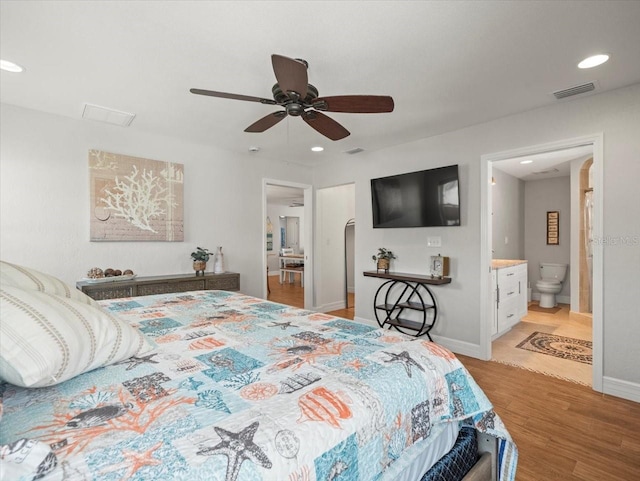 bedroom featuring light wood-style flooring, ensuite bathroom, visible vents, baseboards, and recessed lighting