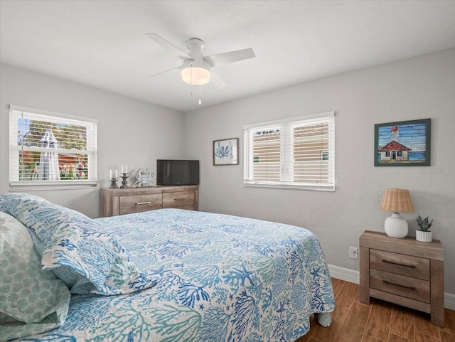 bedroom featuring baseboards, ceiling fan, and wood finished floors