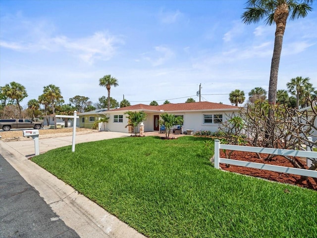 single story home featuring a front yard, stucco siding, and driveway