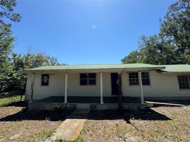 view of front facade featuring a porch and metal roof