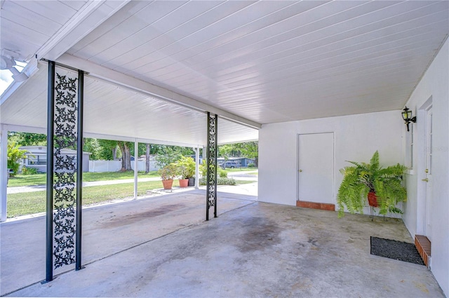 view of patio featuring fence and an attached carport