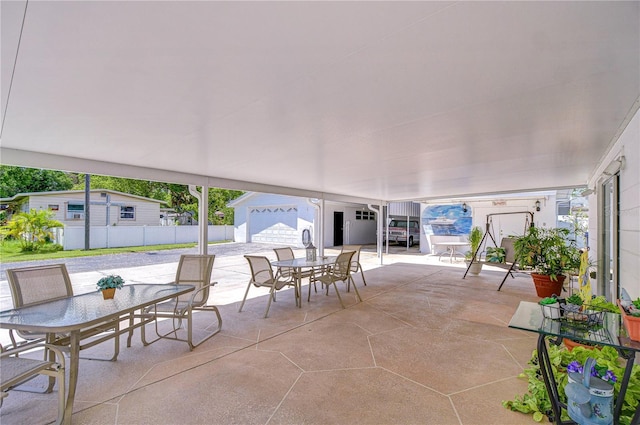 view of patio with fence and outdoor dining area