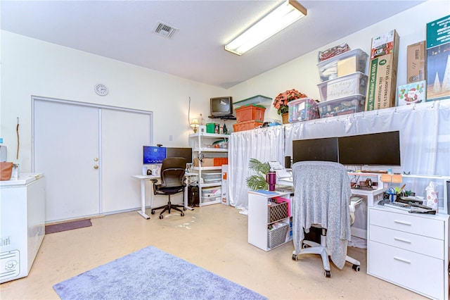 office area featuring concrete floors and visible vents