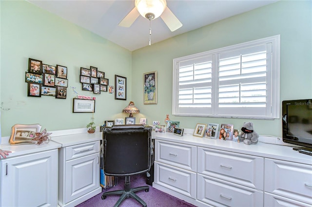 home office featuring dark carpet and a ceiling fan
