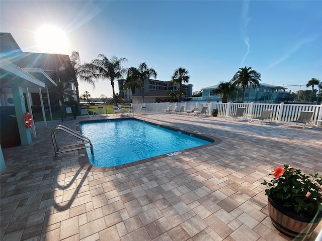 community pool featuring a patio and fence