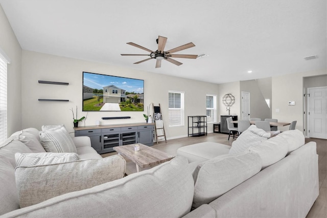 7721 Twin Leaf Ter, Parrish, FL 34219 - living area with plenty of natural light, a ceiling fan, wood finished floors, and visible vents