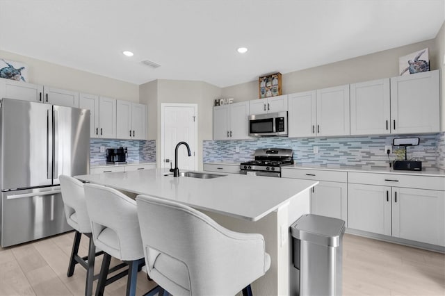 7721 Twin Leaf Ter, Parrish, FL 34219 - kitchen featuring visible vents, light countertops, tasteful backsplash, a sink, and appliances with stainless steel finishes