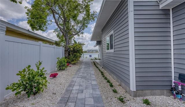 8635 Boca Ciega Dr, St Pete Beach, FL 33706 - view of side of home featuring fence