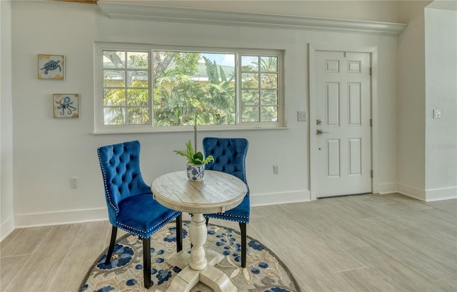 8635 Boca Ciega Dr, St Pete Beach, FL 33706 - interior space featuring baseboards, crown molding, wood finished floors, and a healthy amount of sunlight