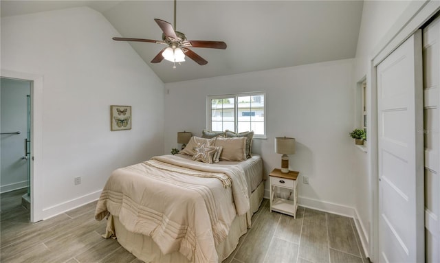 8635 Boca Ciega Dr, St Pete Beach, FL 33706 - bedroom featuring baseboards, ceiling fan, light wood finished floors, and high vaulted ceiling