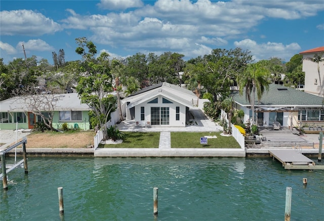 8635 Boca Ciega Dr, St Pete Beach, FL 33706 - rear view of property featuring a yard, a water view, fence, and a patio area