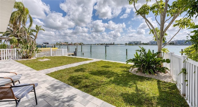 8635 Boca Ciega Dr, St Pete Beach, FL 33706 - view of yard with a dock, a water view, fence, and a patio