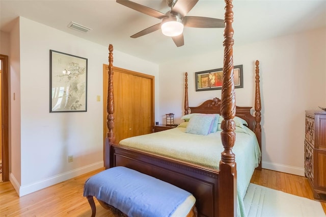 bedroom featuring baseboards, a ceiling fan, light wood-style flooring, and visible vents