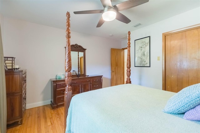 bedroom featuring baseboards, a ceiling fan, light wood-type flooring, and visible vents